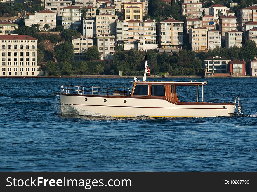 Classical powerboat passing through Straits of Bhosporus. Istanbul. Turkey