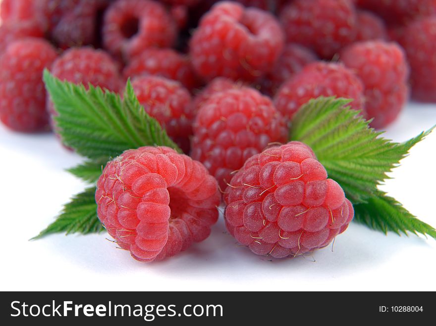 Raspberry with leaves on a white background