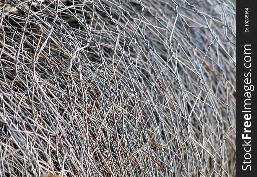 Sharp macro of a rolled metal wire fence. Sharp macro of a rolled metal wire fence.