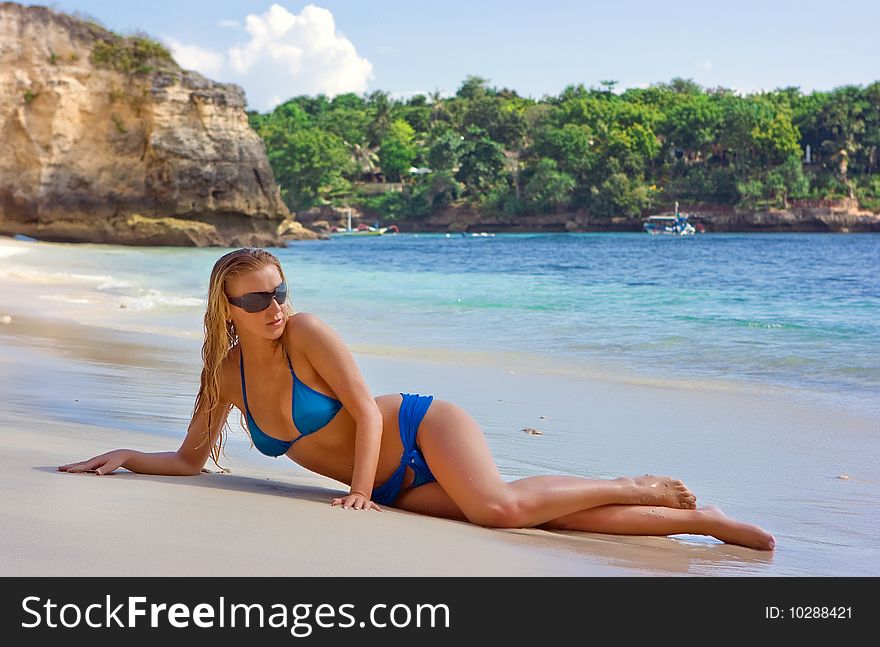 Blonde lady lying in water on the beach