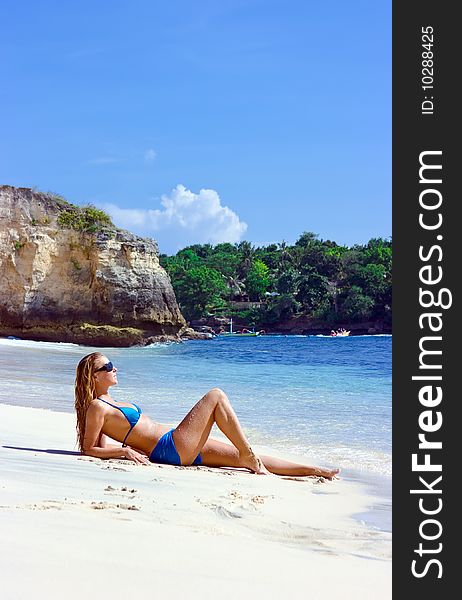 Blonde girl lying on the beach of Bali island. Blonde girl lying on the beach of Bali island