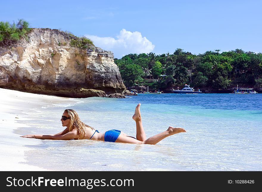 Blonde girl lying on the beach of Bali island. Blonde girl lying on the beach of Bali island