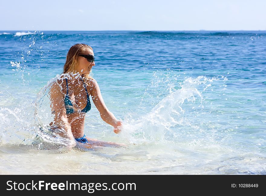 Girl Making Splashes In The Sea