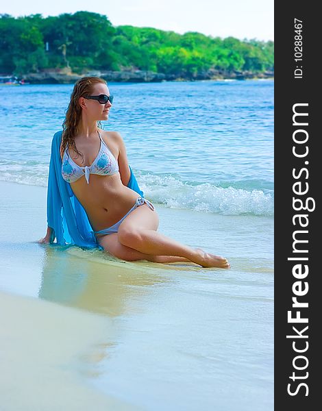 Brunette Girl Relaxing On The Beach