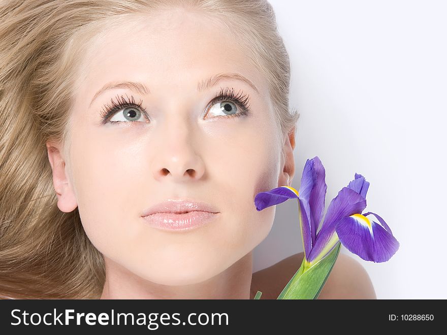 Close-up beautiful young fresh purity blonde lady with flower. Close-up beautiful young fresh purity blonde lady with flower