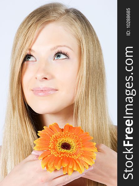 Close-up beautiful young fresh blonde lady with flower. Close-up beautiful young fresh blonde lady with flower