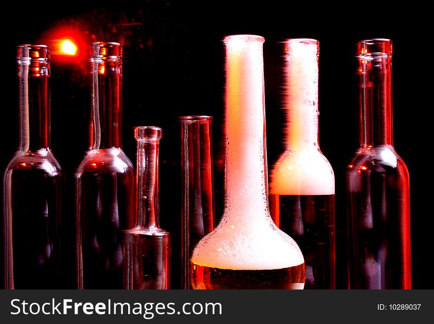 A nice set of different shaped bottles on a black background. A nice set of different shaped bottles on a black background