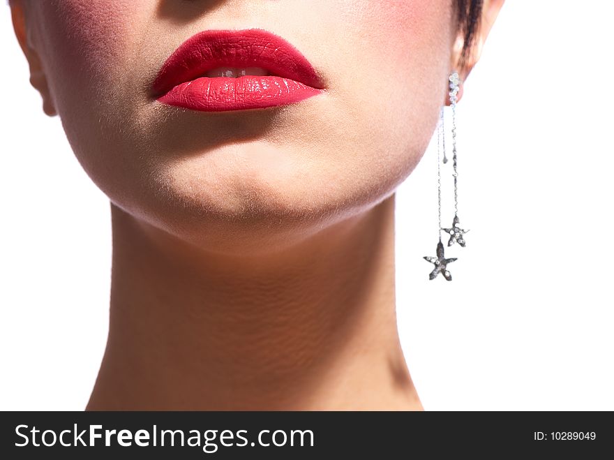 The lower part of the face a girl with bright red lips and earrings to the ear in the form of stars