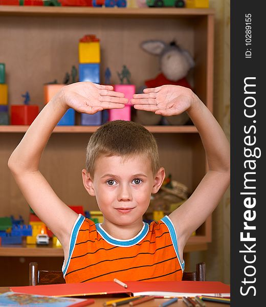 The boy of 7 years is engaged in a children's room