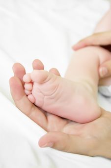 Woman Hand Holds Baby Leg Royalty Free Stock Photo