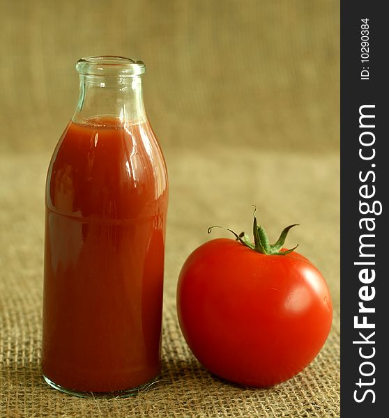 Tomatoes and juice in the beige background. Tomatoes and juice in the beige background