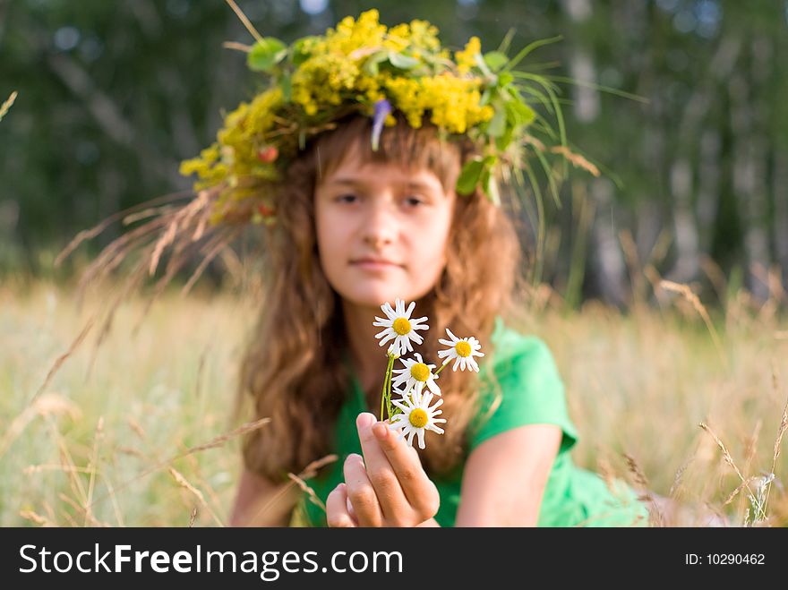 A young girl lies on a meadow