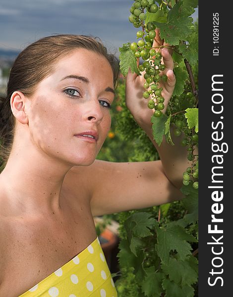 Young attractive Woman with grapes in her hand