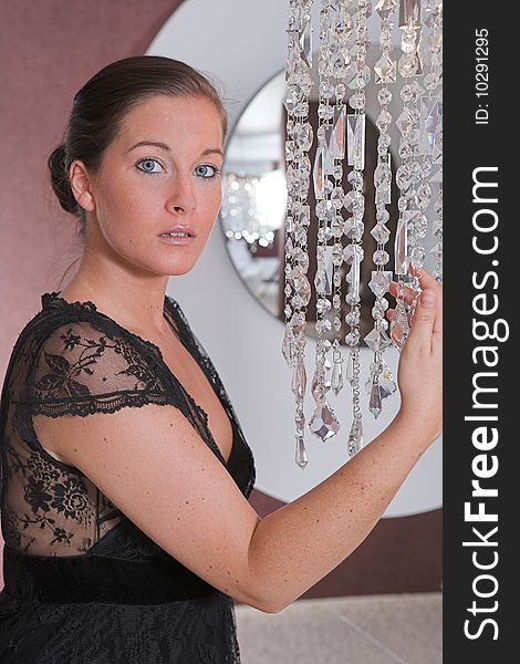 Young attractive Woman posing in front of a mirror with glitter chain