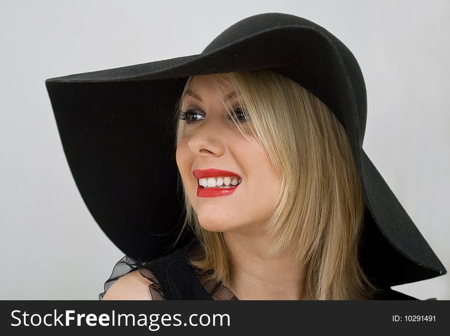 Woman in hat smiling and looking ahead