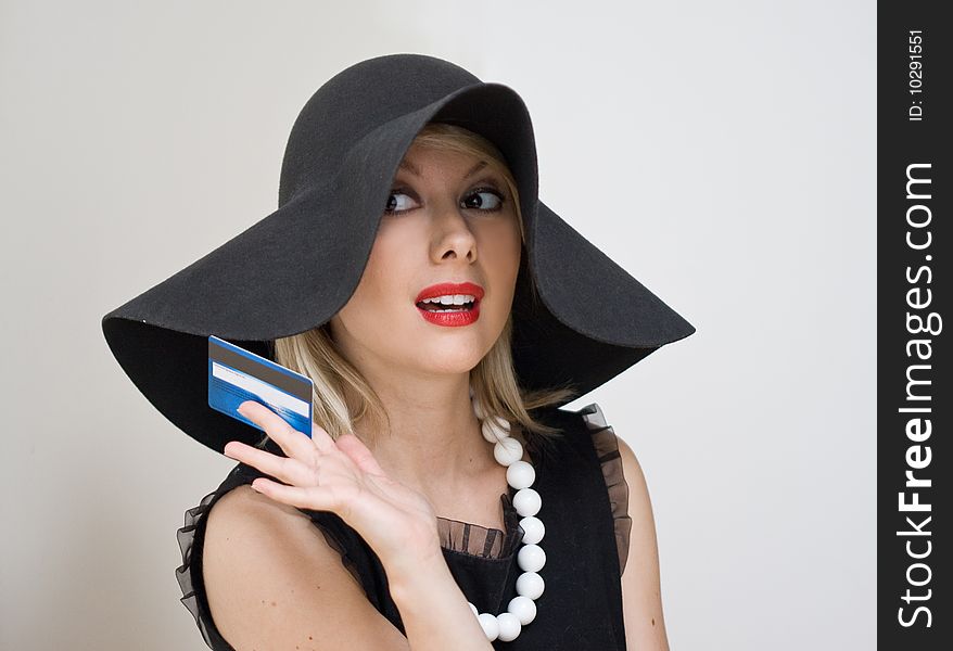 Lady in the hat holding the payment card. Lady in the hat holding the payment card