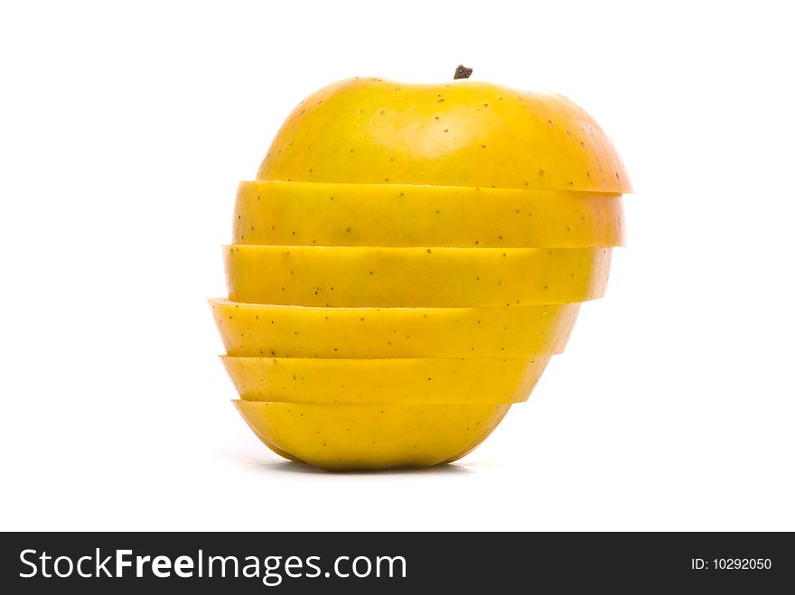 Sliced yellow apple on studio white