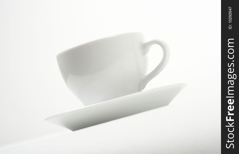 White cup and saucer on white background