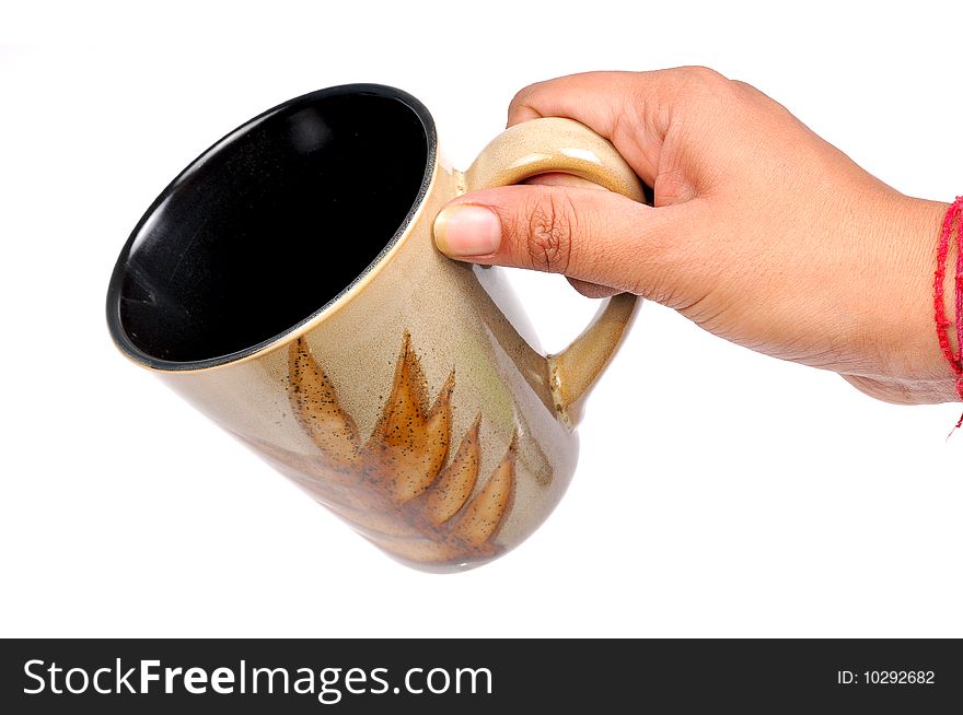 Female hand holding cup over white background. Female hand holding cup over white background.