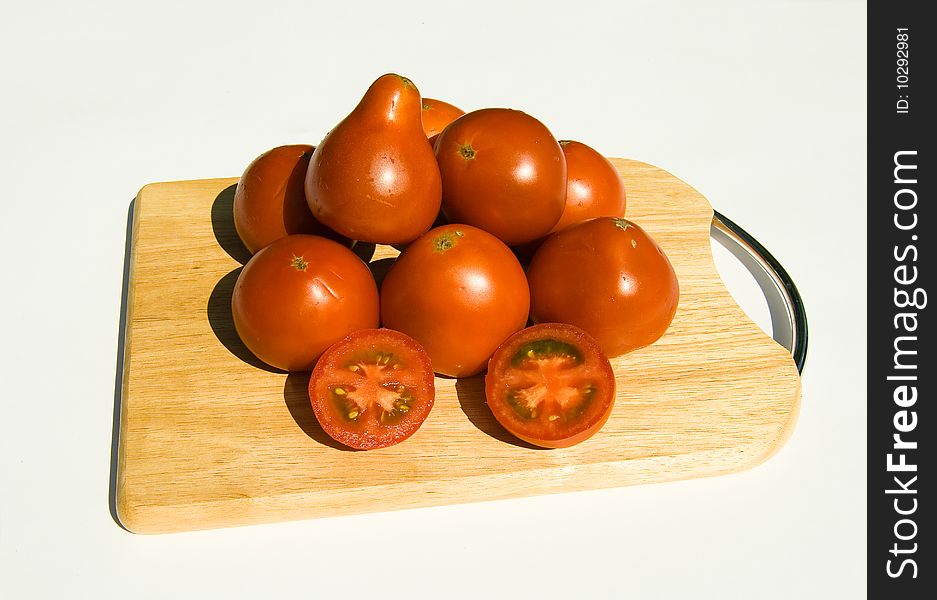 Ripe tomatoes on cutting board