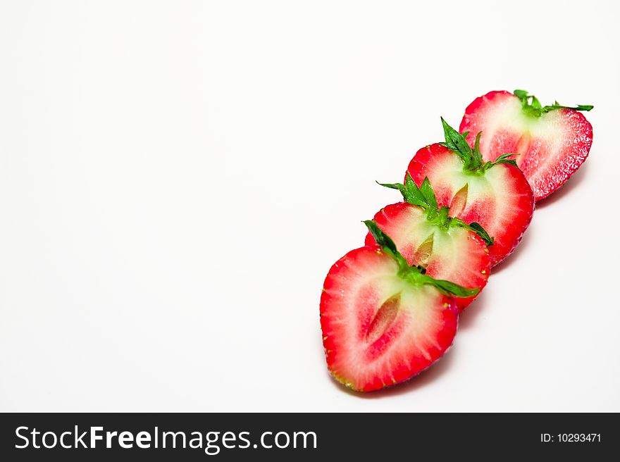 Row of freshly sliced strawberries on white background. Row of freshly sliced strawberries on white background