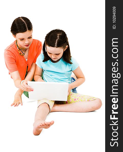 Girls using a laptop isolated over white