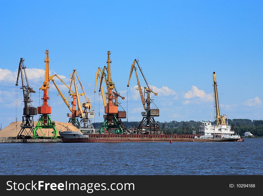 The ship at a pier expects loading. The ship at a pier expects loading