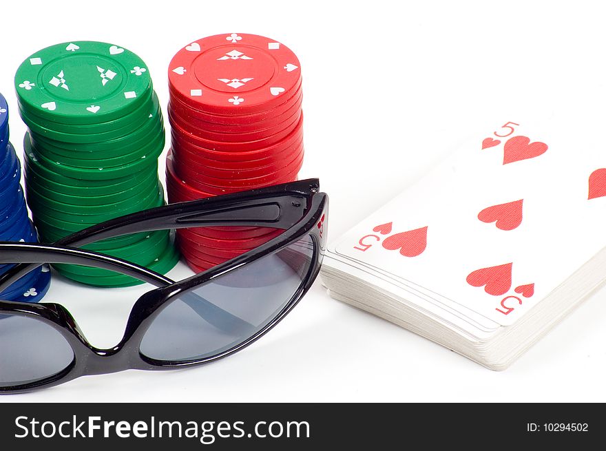 A deck of cards and casino chips isolated on white