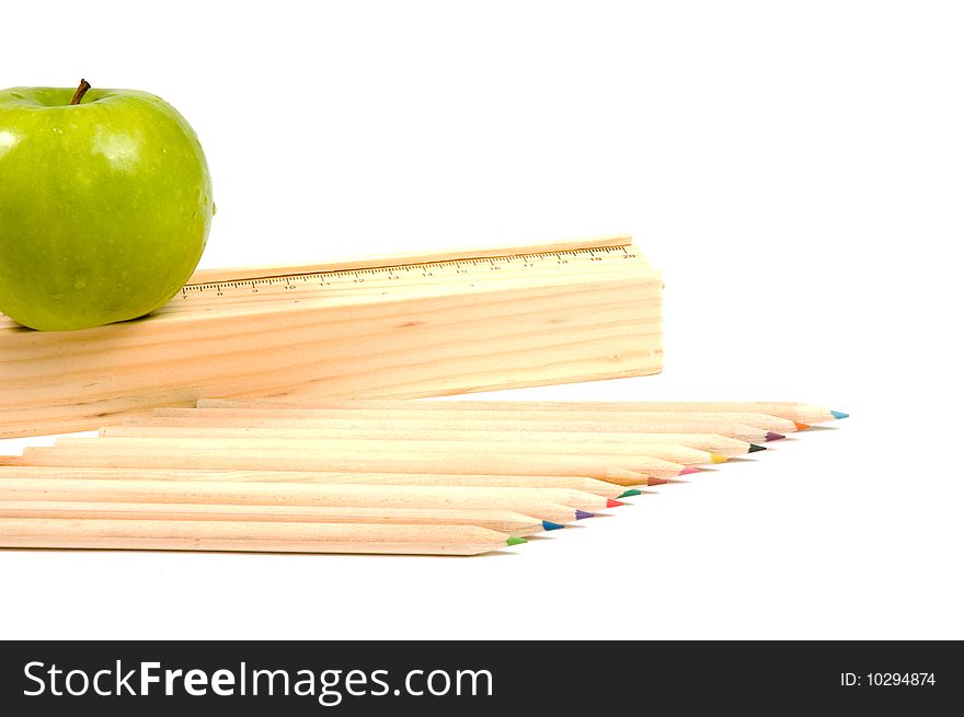 Wooden school pencils and holder with rule and apple on white