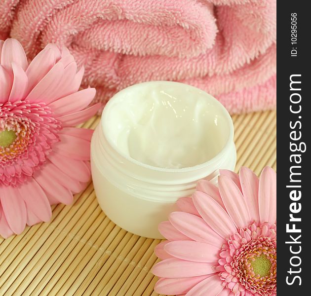 Face cream, towel and flowers.