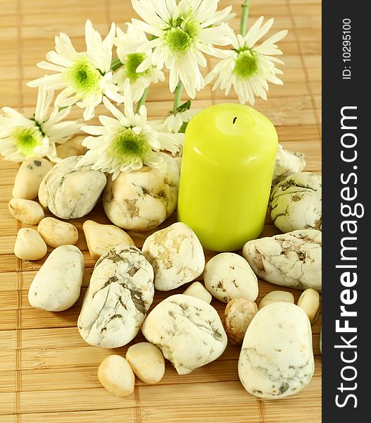 Spa concept. Candle, stones and white flowers. Spa concept. Candle, stones and white flowers.