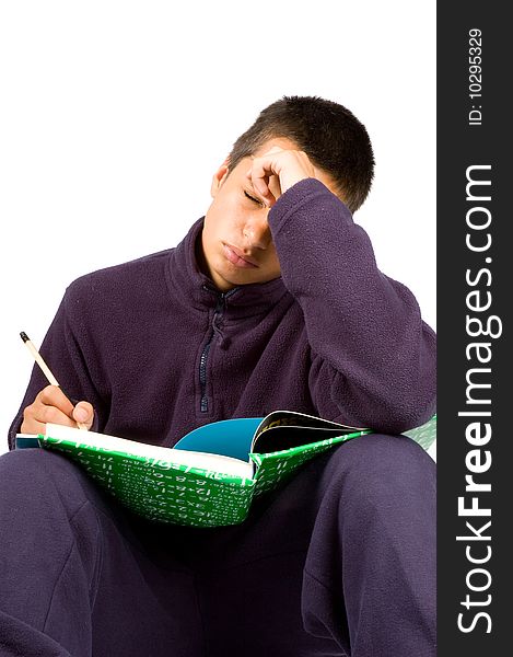 Pakistan schoolboy is tired making homework isolated on white