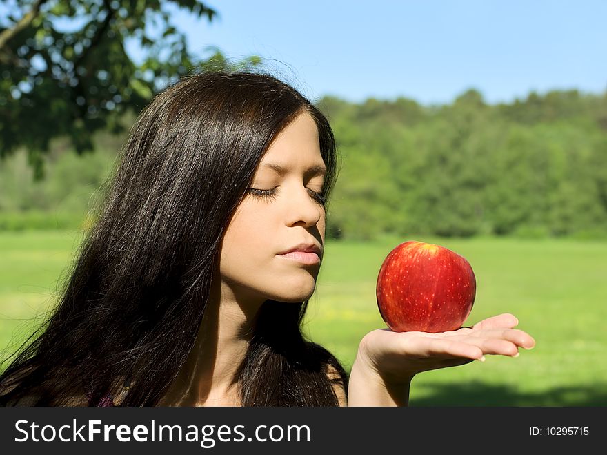 Pretty young woman with red apple
