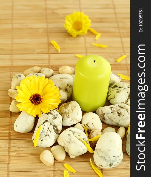 Spa concept. Candle, stones and flowers.