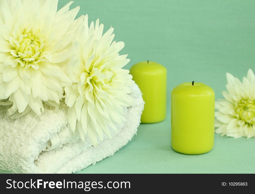 Spa essentials. Towel, candles and flowers.