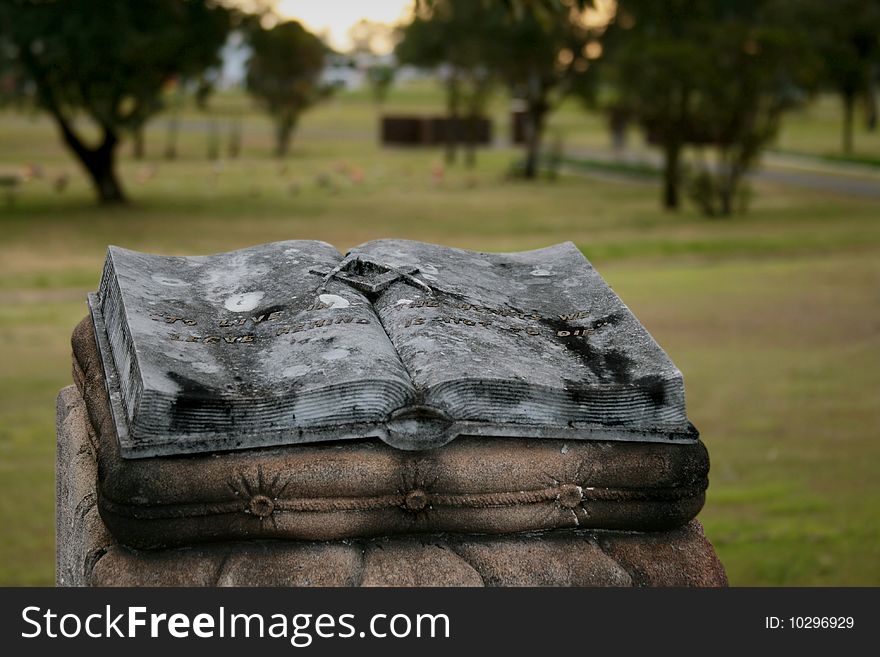 Old headstone with epitaph deteriorating in a cemetery. Old headstone with epitaph deteriorating in a cemetery