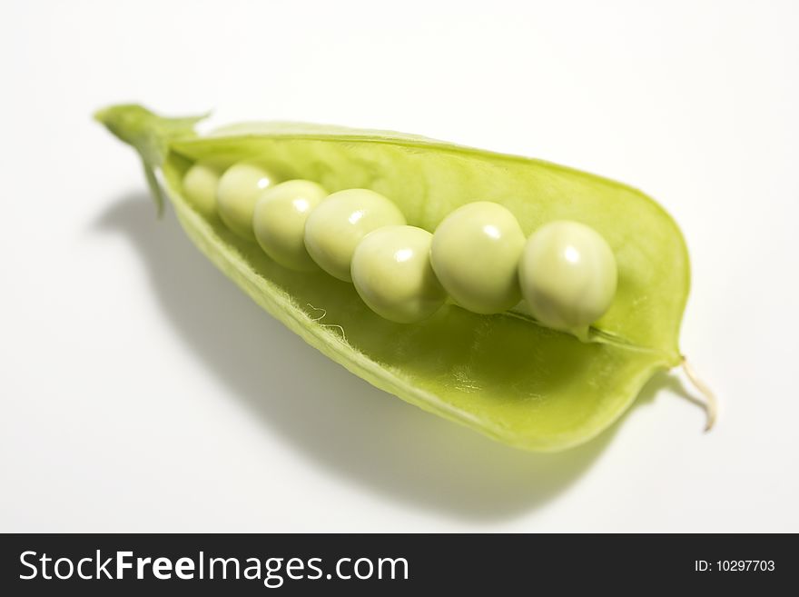 Pods of green peas on white background
