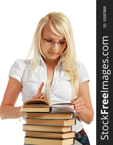 Young girl leaned over pile of books