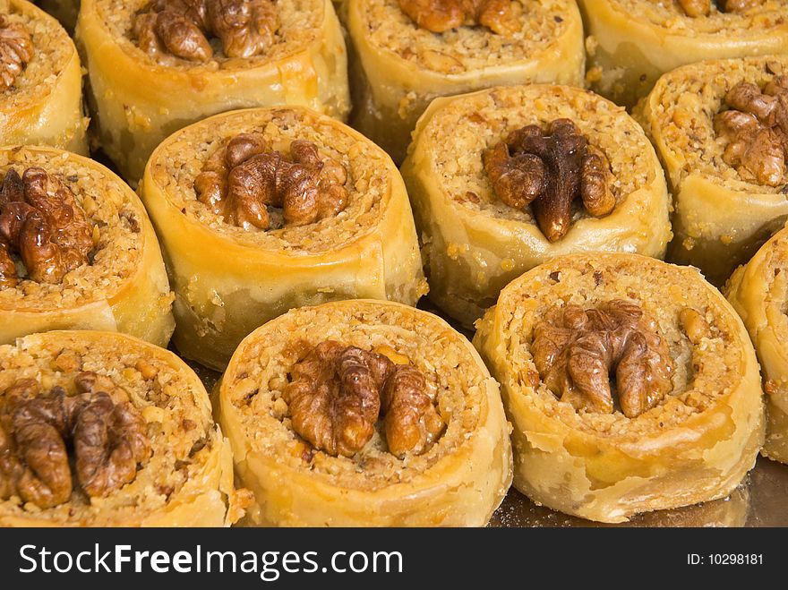 The baklava (a dessert made of thin pastry, nuts, and honey)