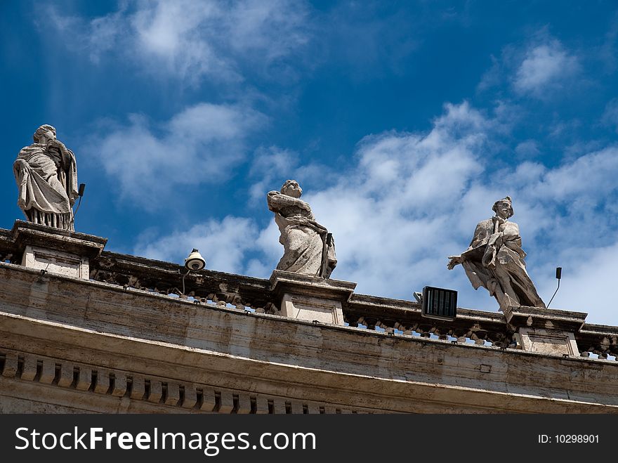 Religious Catholicism sculpture on roof against blue sky. Religious Catholicism sculpture on roof against blue sky
