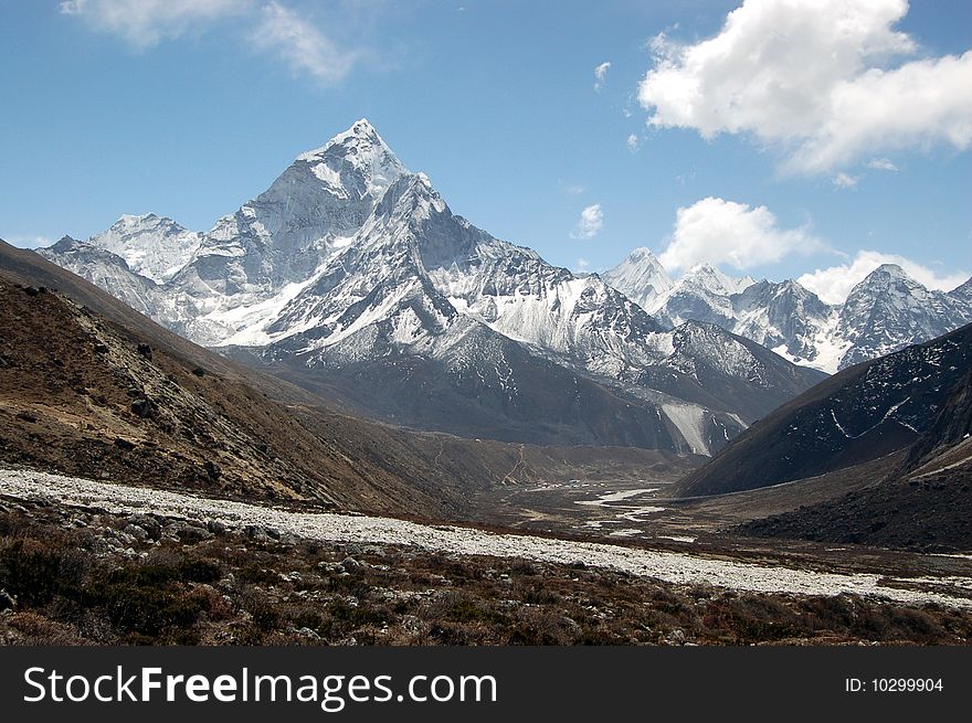 Ama Dablam is a mountain in the Himalaya range of eastern Nepal. The main peak is 6,812 metres (22,349 ft), the lower western peak is 5,563 metres (18,251 ft). Ama Dablam means Mother and Pearl Necklace. Ama Dablam is a mountain in the Himalaya range of eastern Nepal. The main peak is 6,812 metres (22,349 ft), the lower western peak is 5,563 metres (18,251 ft). Ama Dablam means Mother and Pearl Necklace