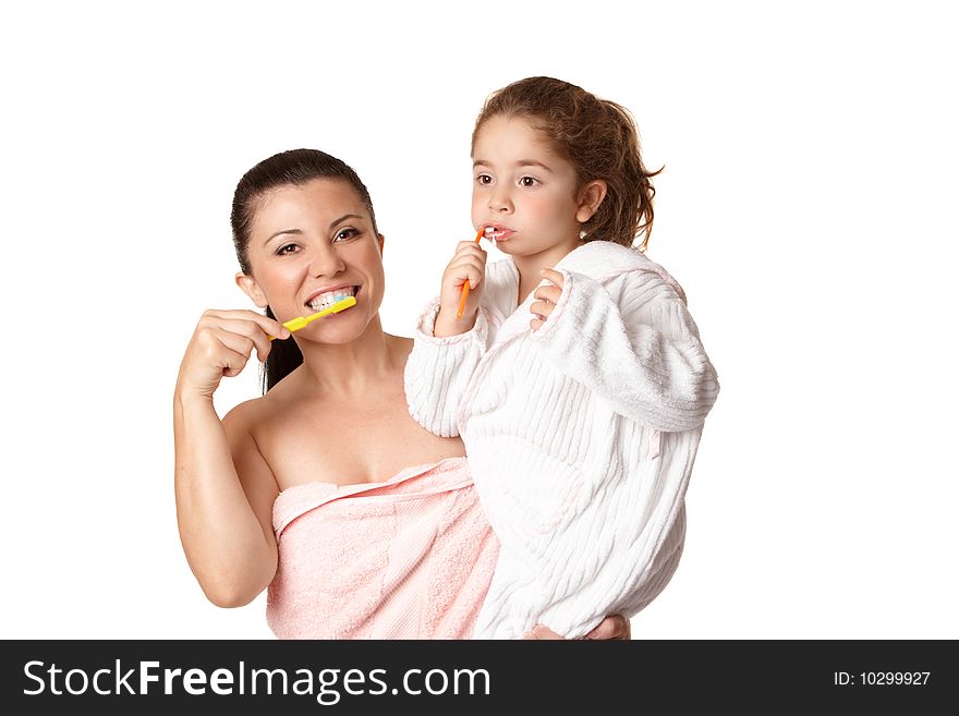 A mother and daughter brushing teeth using toothbrushes and aqua coloured mint flavoured toothpaste.