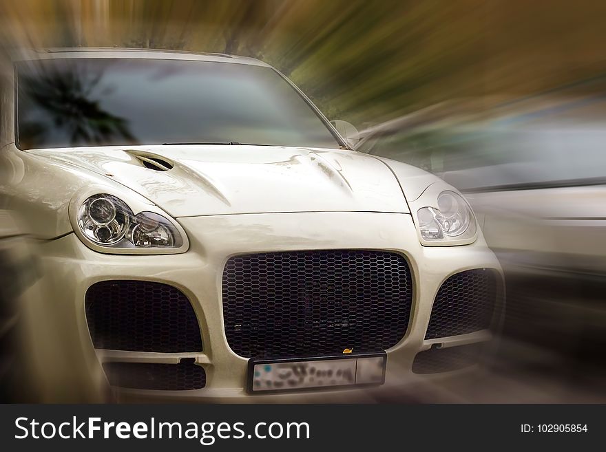 White car on a blurred background in motion. White car on a blurred background in motion.