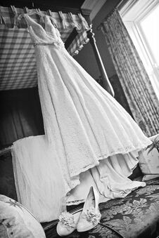 Stunning Wedding Dress Hanging Of A Bed Frame. Stock Photo Stunning Wedding Dress Hanging Of A Bed Frame. Stock Photo