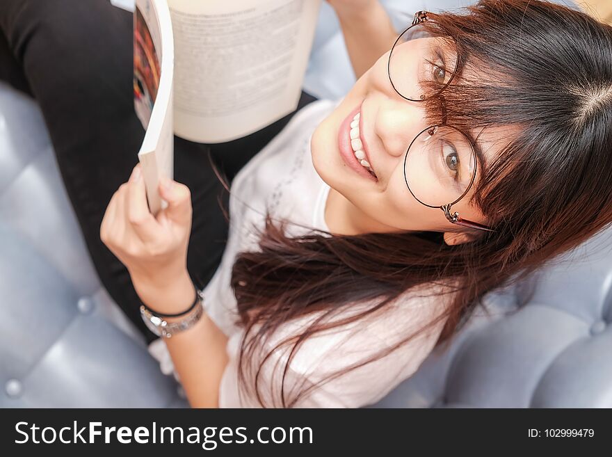 Women Wear Glasses Reading Book On Cozy Sofa