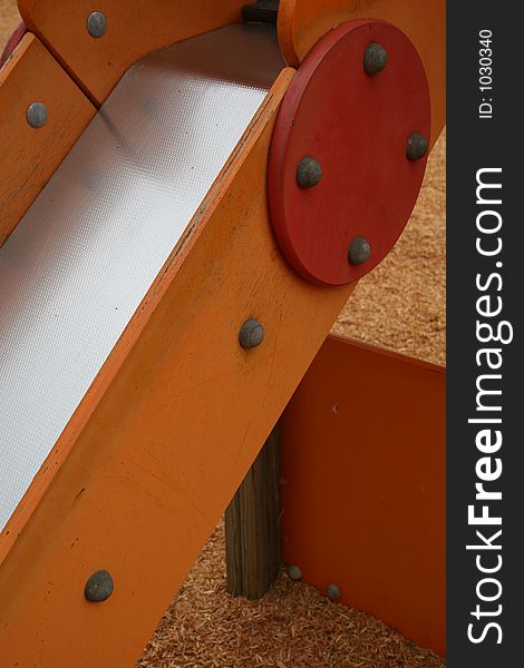 Closeup details of a small, wooden playground slide. Closeup details of a small, wooden playground slide.