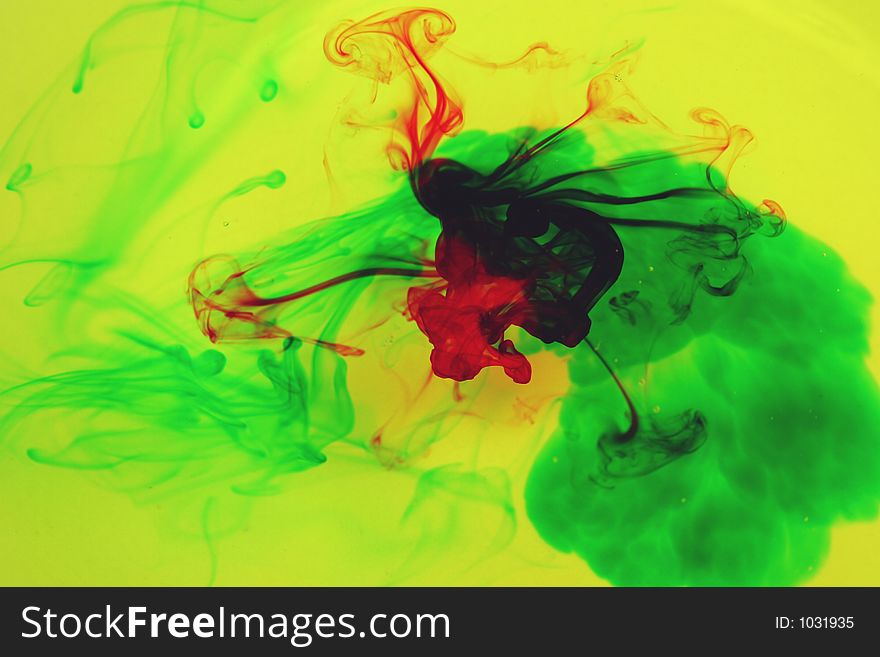Yellow liquid with red and green dye introduced to create abstract images. Yellow liquid with red and green dye introduced to create abstract images.