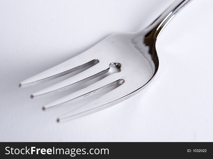 A single fork on a white background. A single fork on a white background