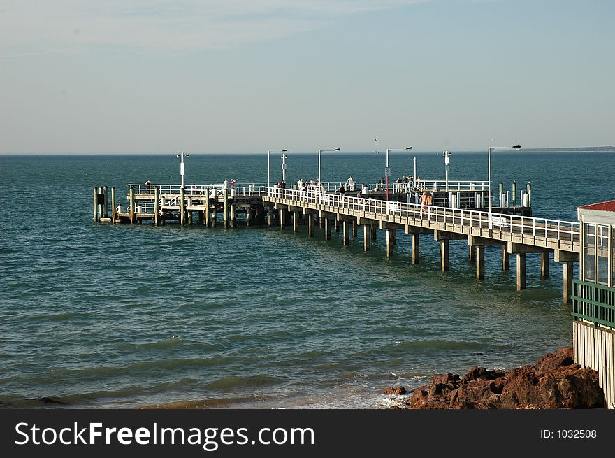 Shot of an island pier crowded with tourists. Shot of an island pier crowded with tourists.