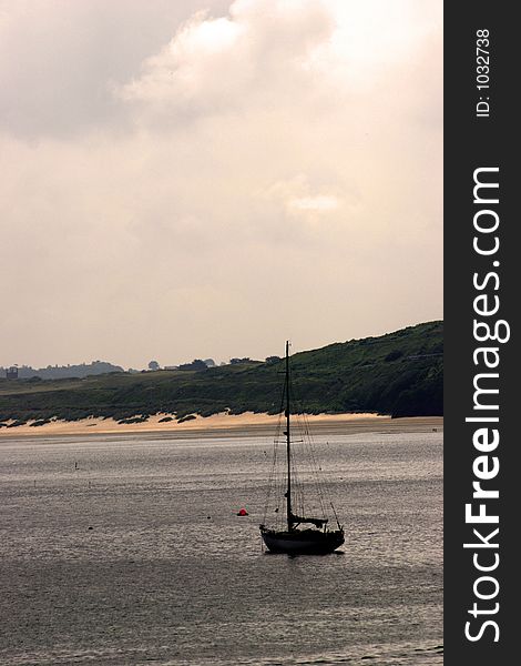 Yacht in harbour at sunset